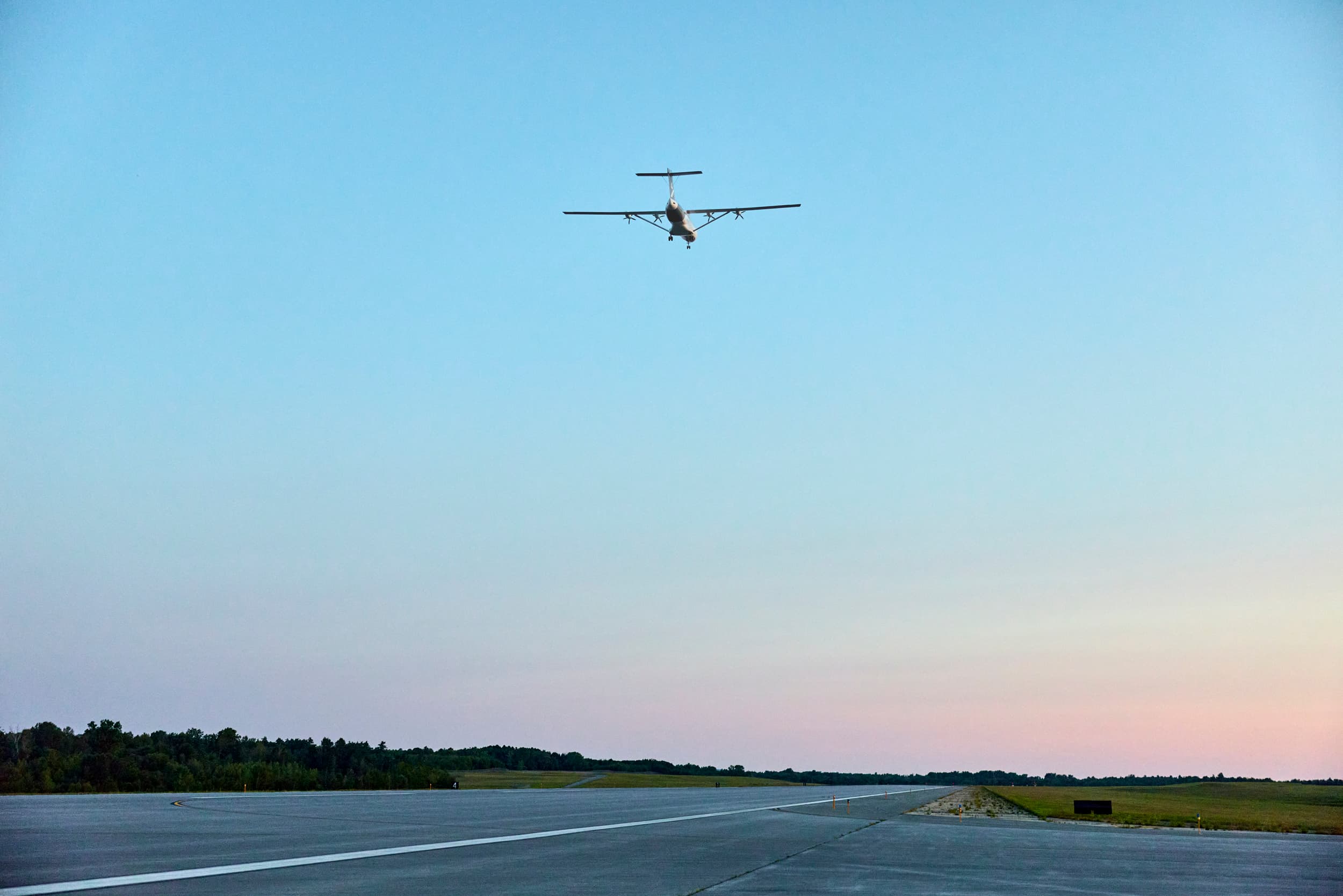 Heart Aerospace’s X1 demonstrator flies above a runway at Plattsburgh International Airport.